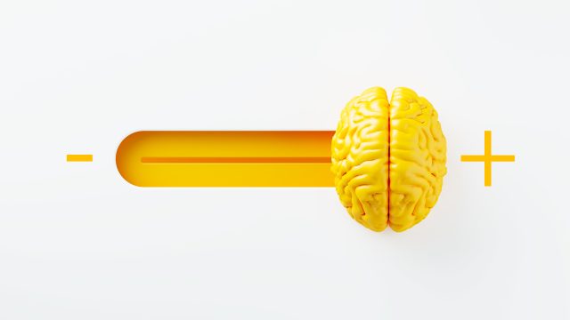Yellow human brain in between minus and plus signs on white background. Horizontal composition. Mental health concept.